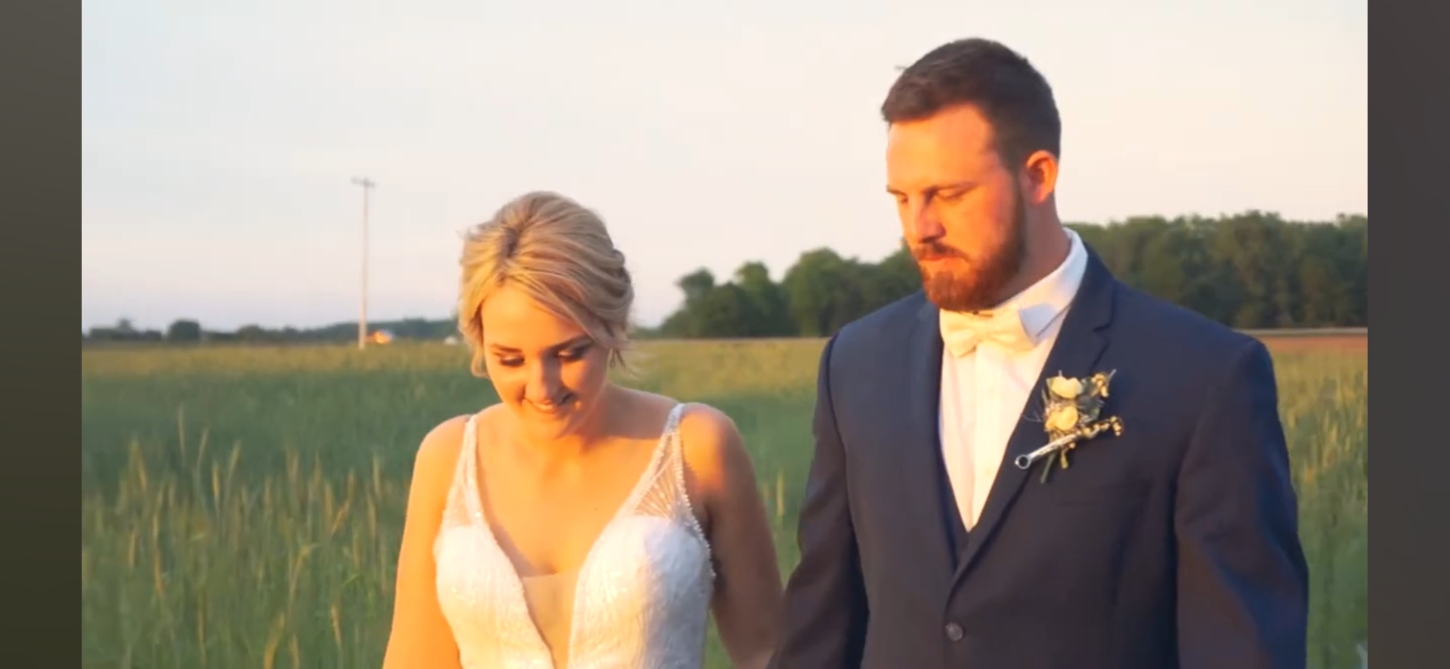 Bride and groom walking together at sunset